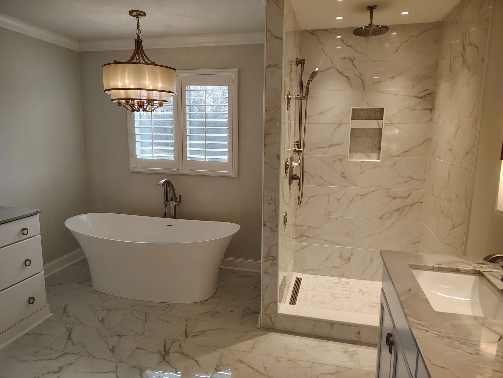 Bathroom remodel with freestanding tub and glass shower by C&M Construction